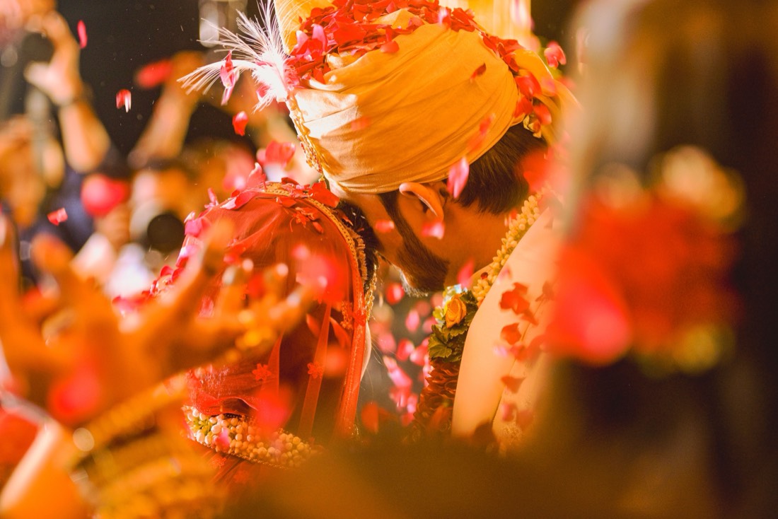 Groom showered with rose petals at a night wedding styled by SGR Decorators
