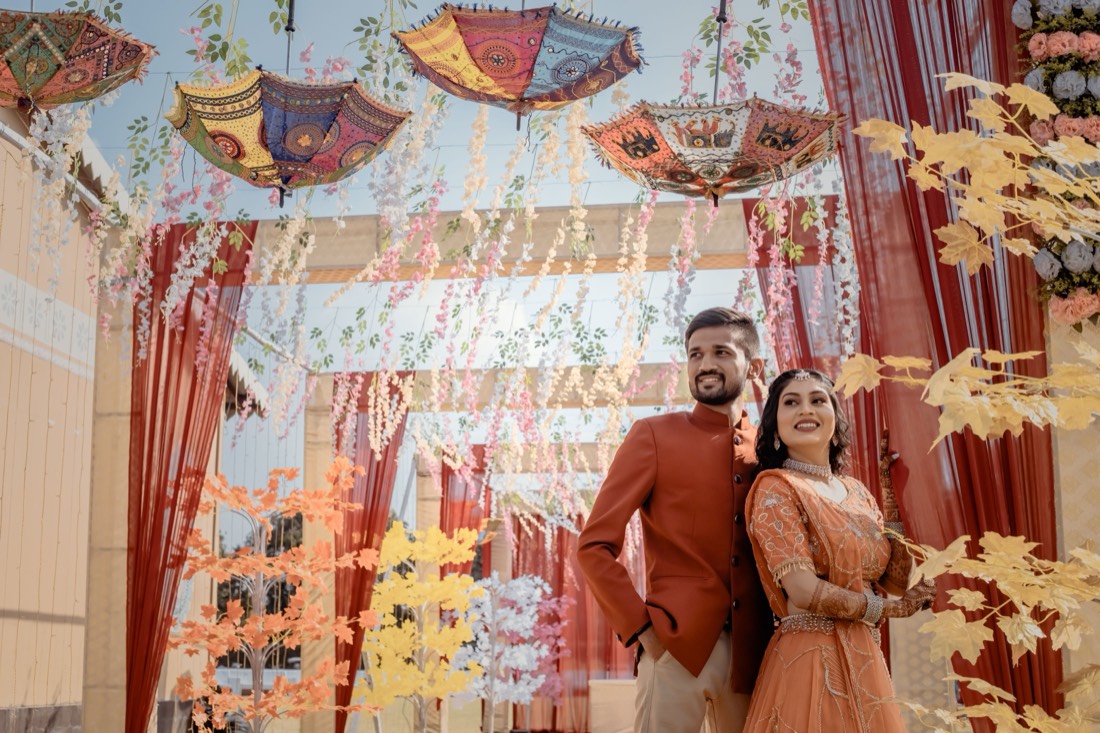 Mehendi entrance decor with red drapery and floral streamers by SGR Decorators